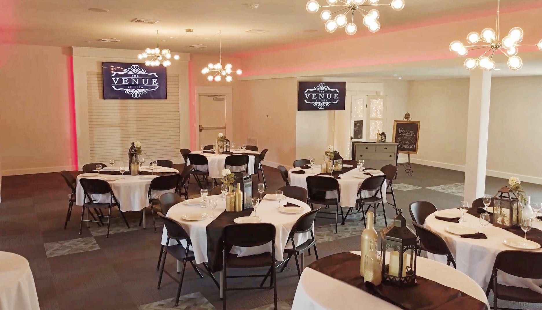 a large room with tables and chairs set up for a wedding reception .