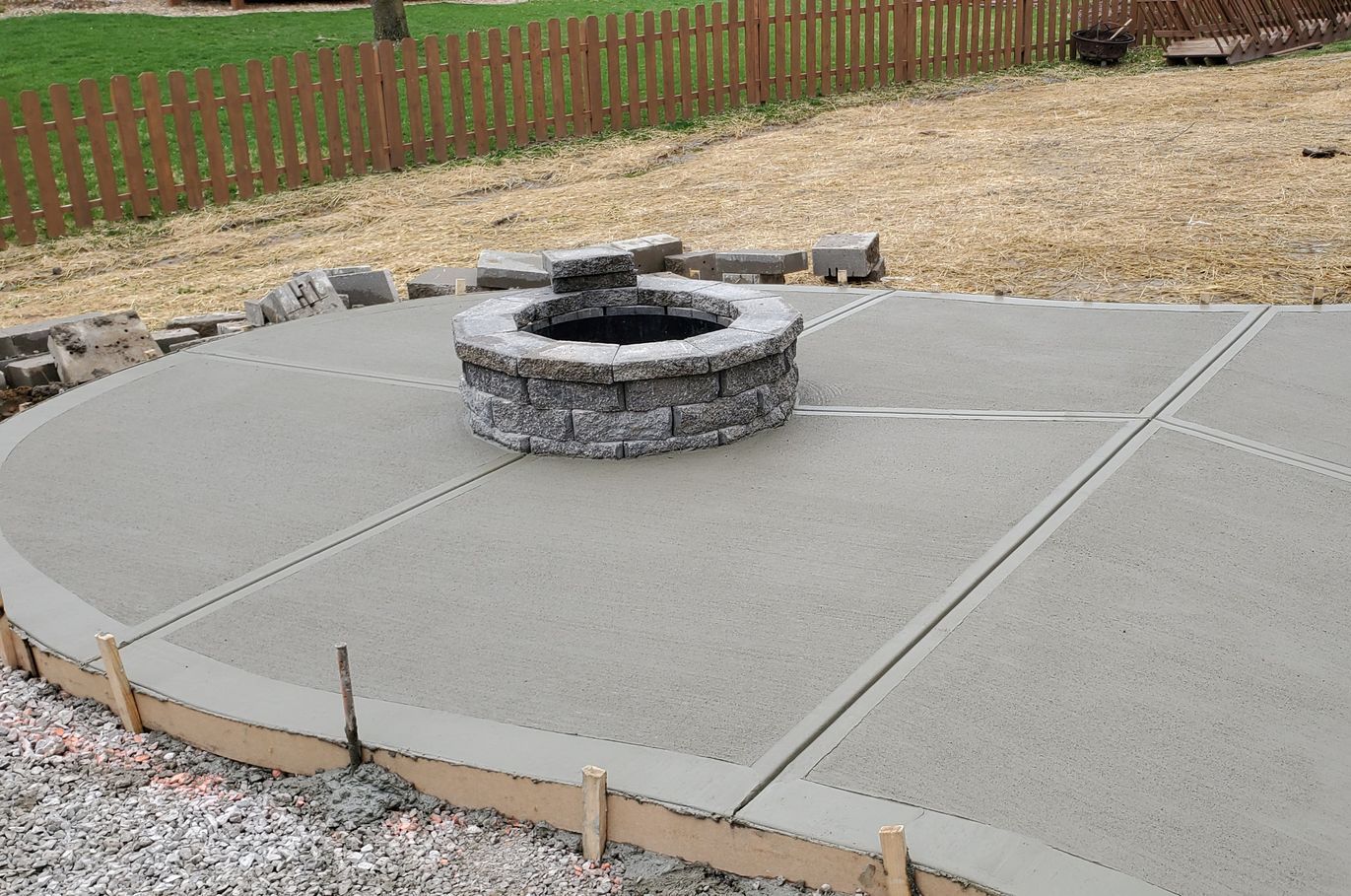 a fire pit is sitting on top of a concrete patio .