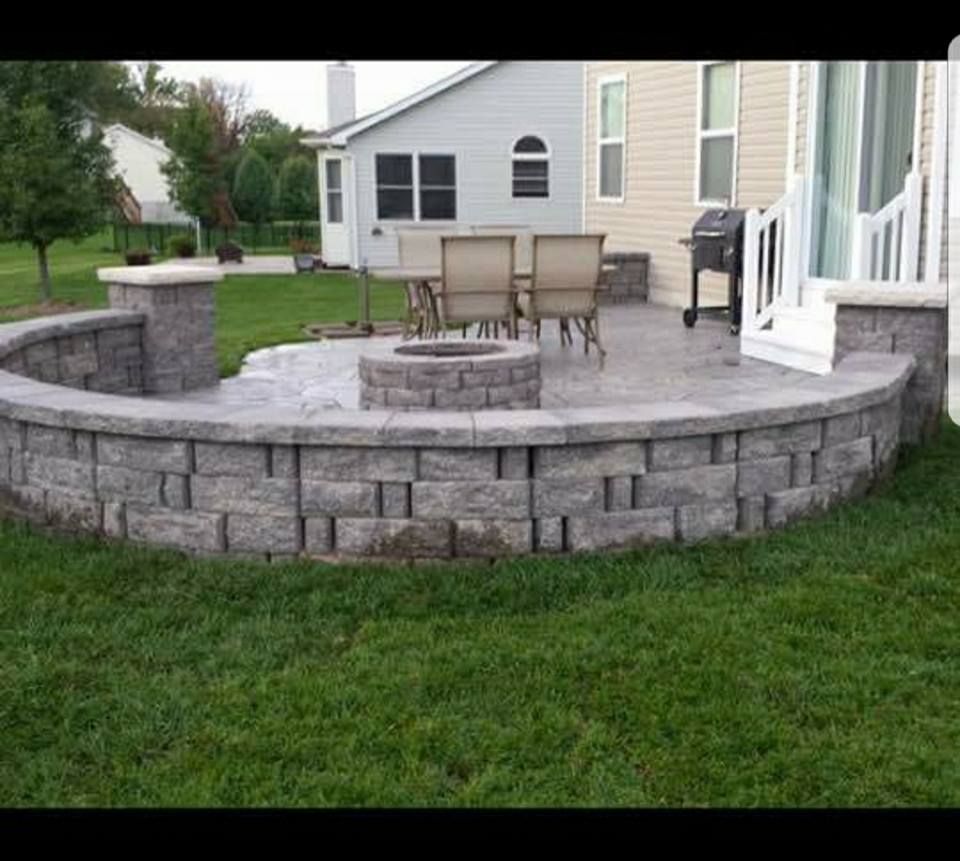 there is a fire pit in the middle of the patio .