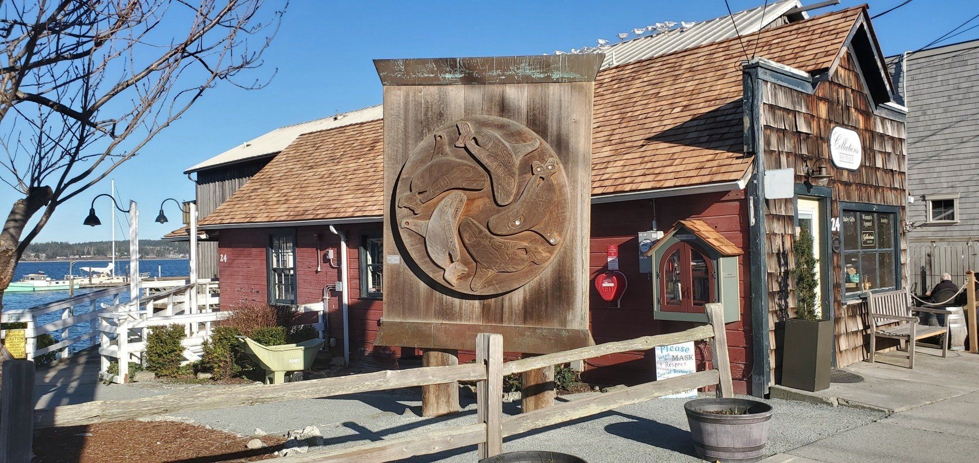 A wooden sign with a horse on it is in front of a building.