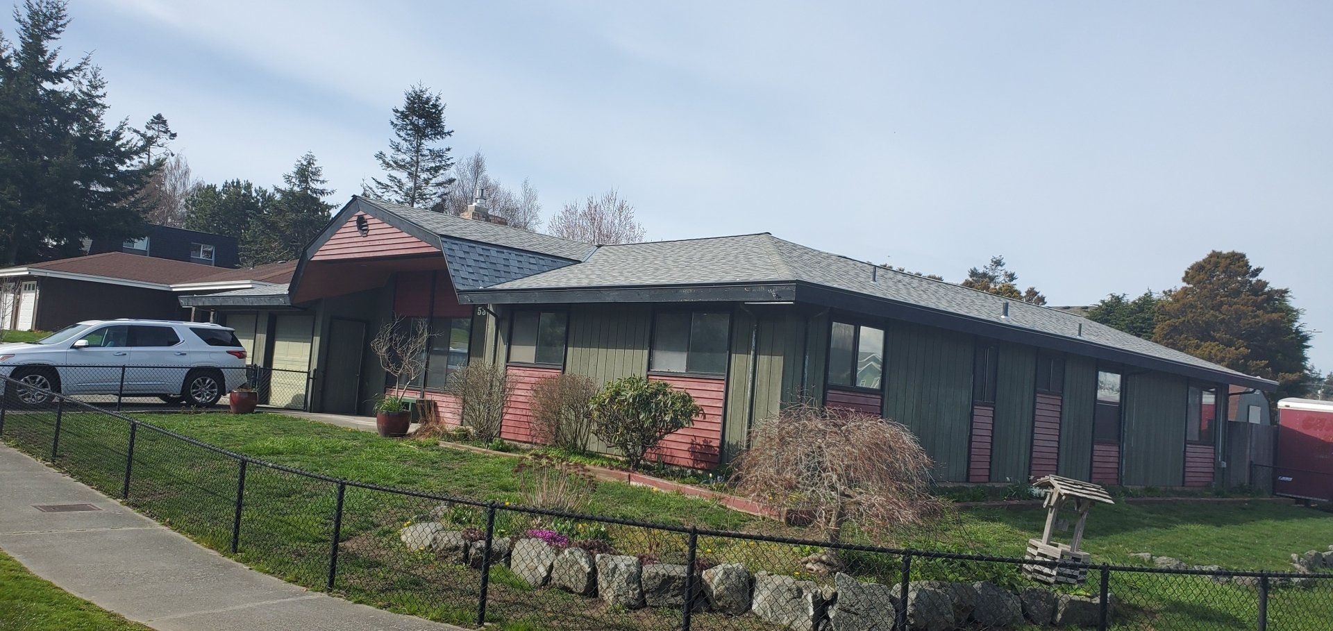 A large house with a car parked in front of it.