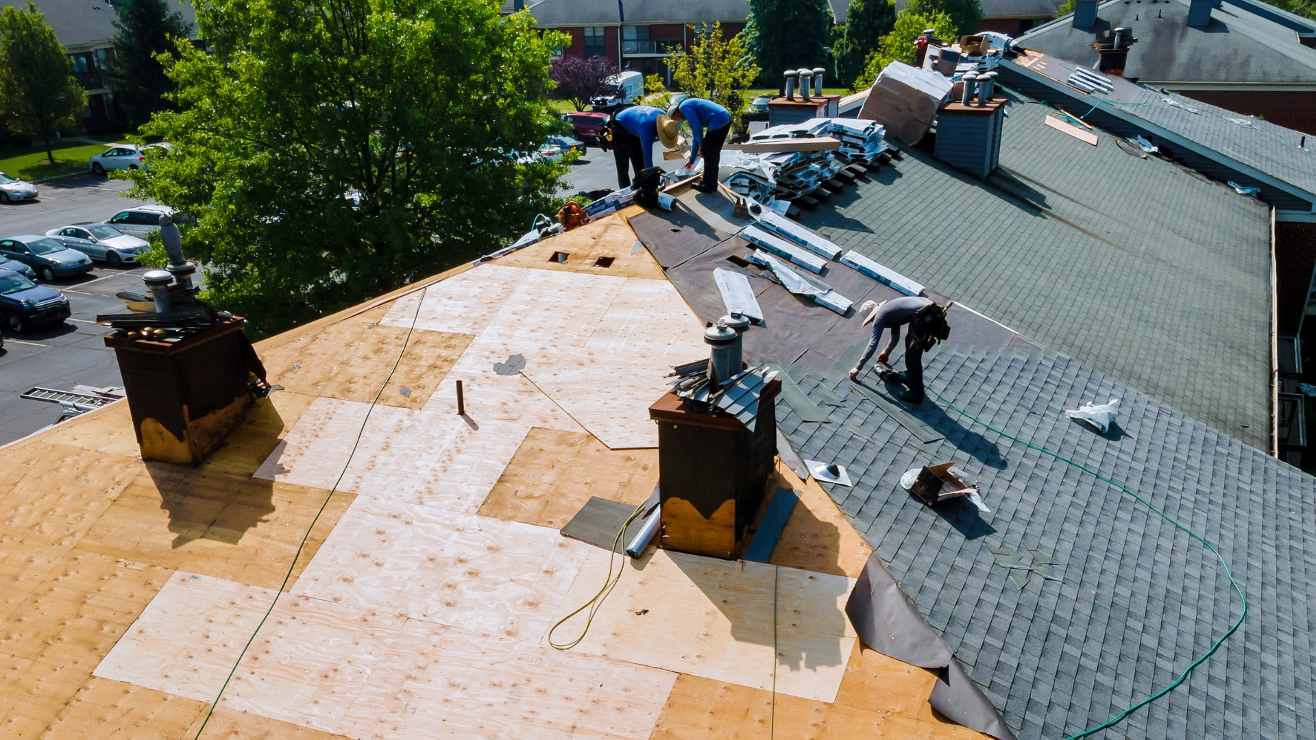 A group of men are working on a roof.