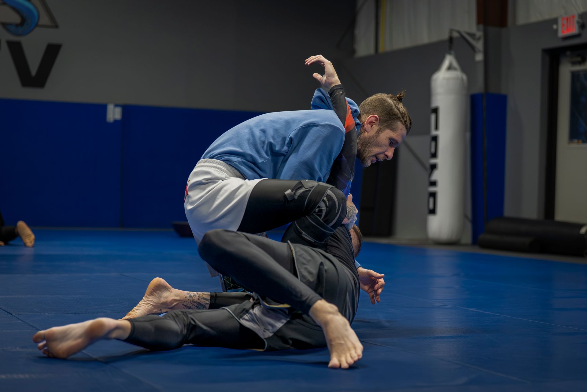 Adults practicing controlled grappling at Gracie Jiu-Jitsu San Jose in San Jose, CA to build focus and energy.