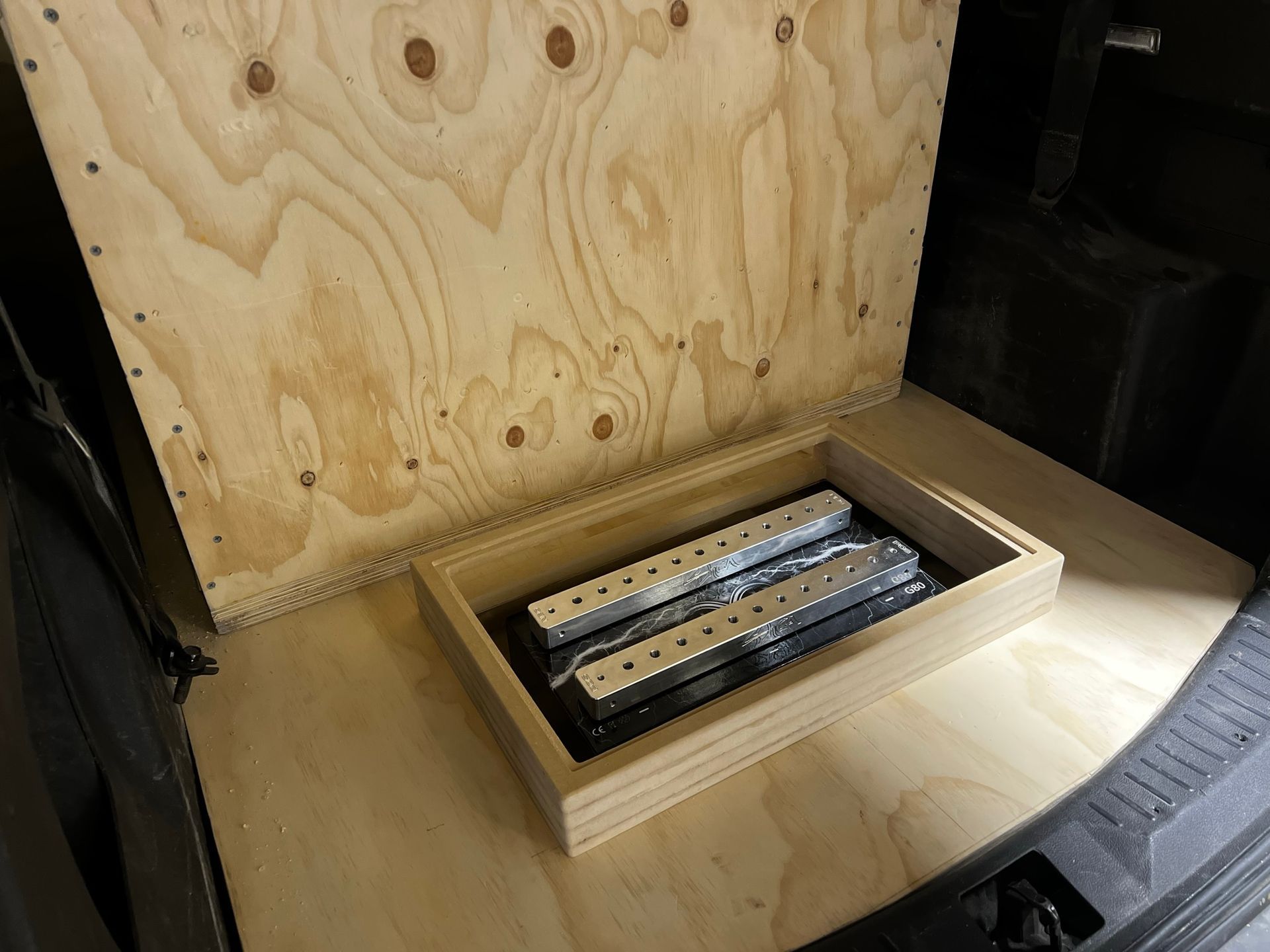 A wooden box is sitting in the back of a car.