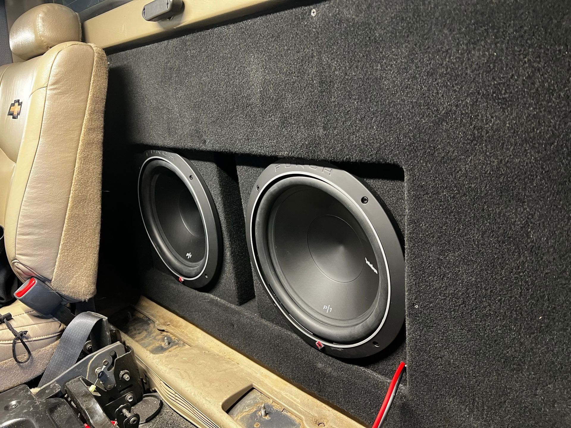 A car with two speakers in the back seat.