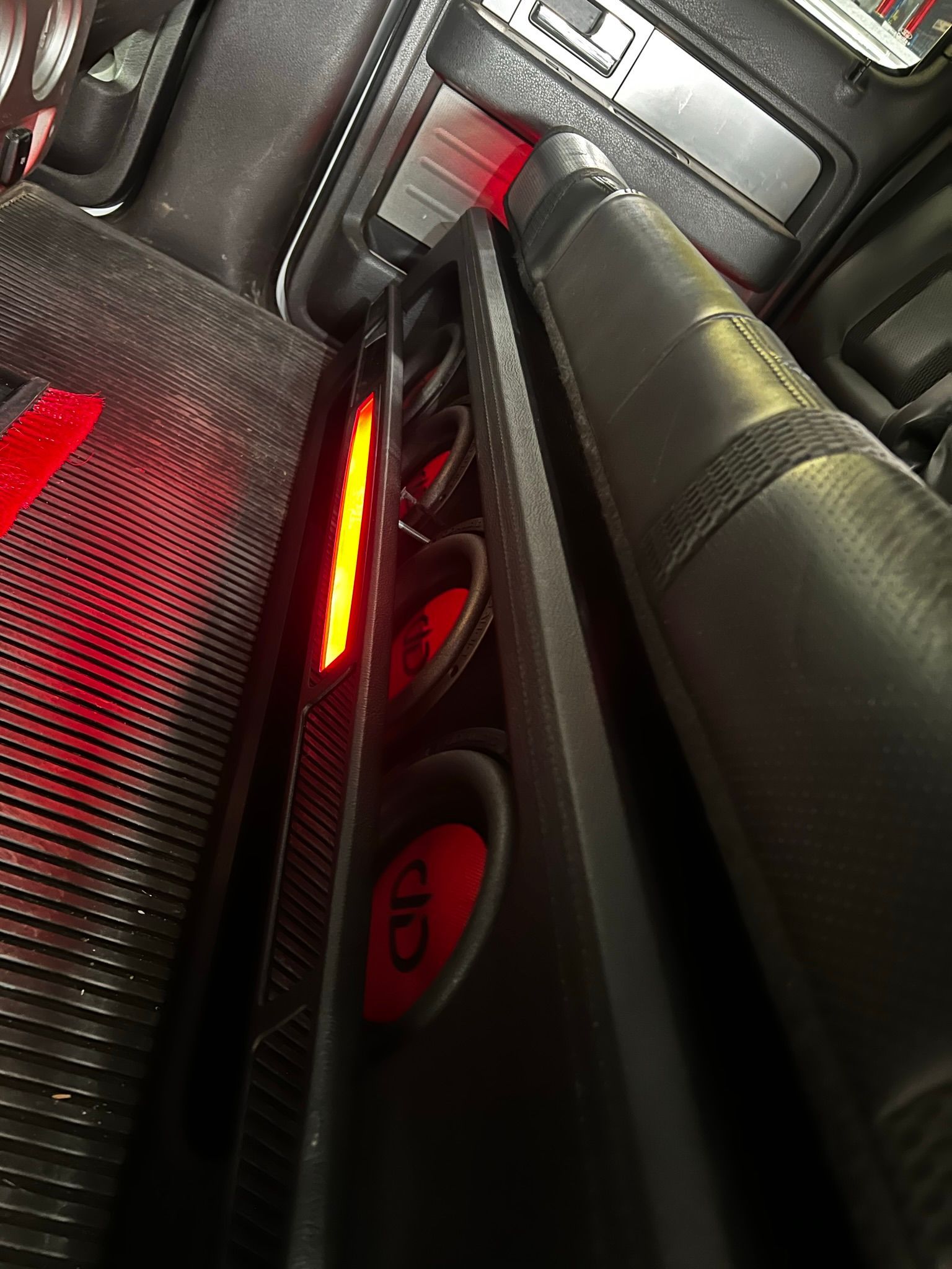 A close up of a red light on a car dashboard.