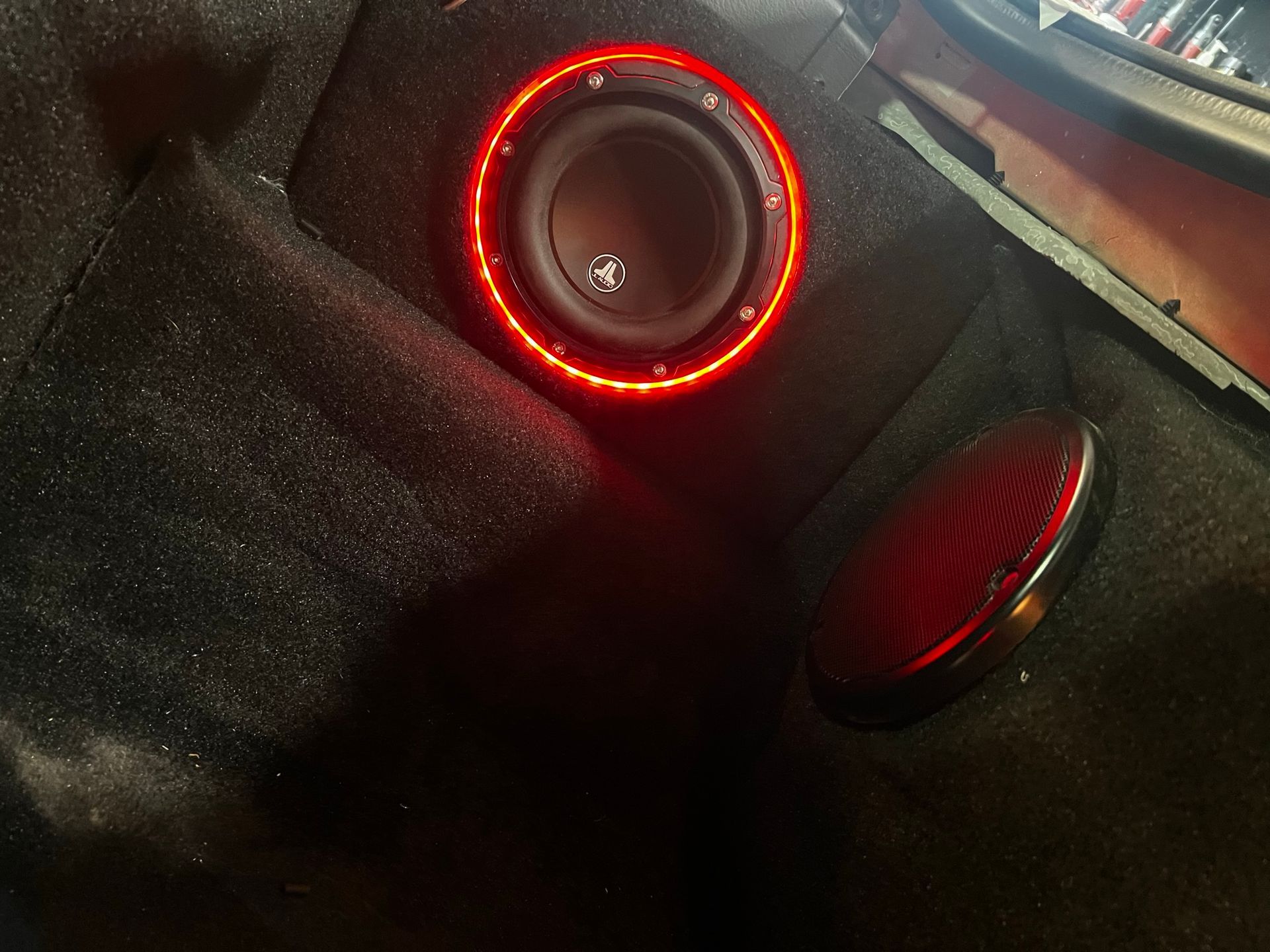 A subwoofer with a red light around it