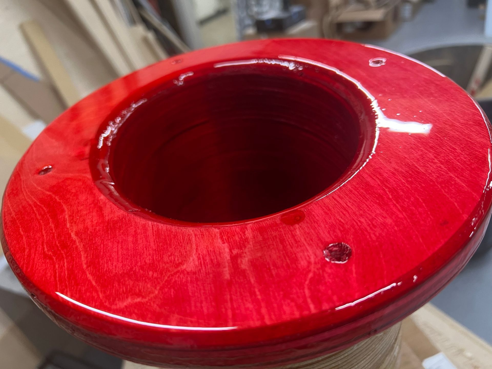 A red circular object with a hole in the middle