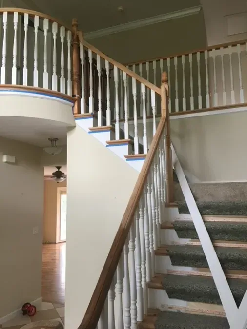 A staircase in a house with white railings