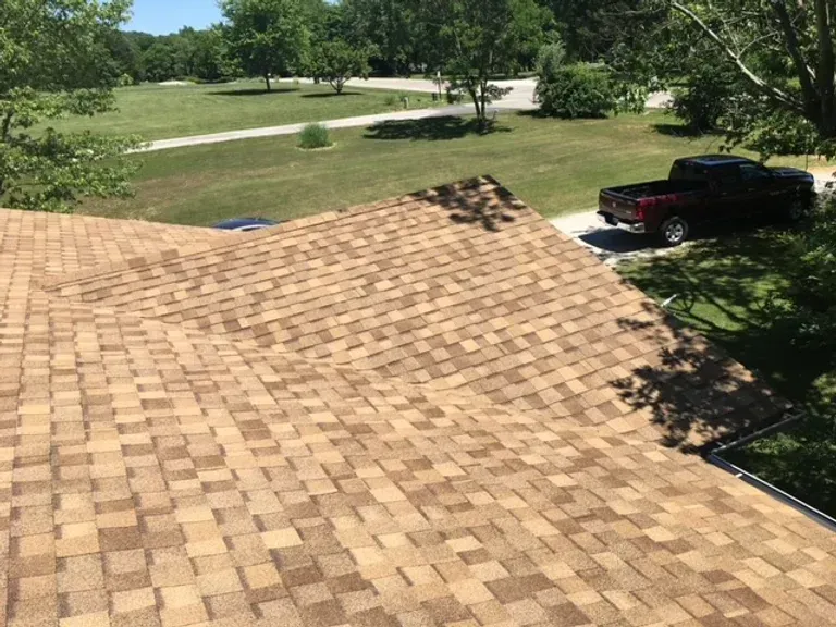 A truck is parked on the roof of a house.