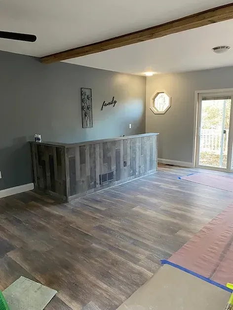 A living room with a wooden bar and a sliding glass door.
