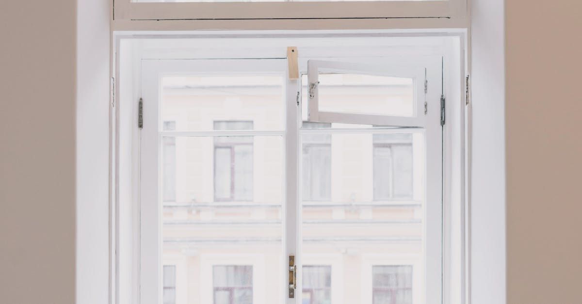 A man is installing a window with a drill.