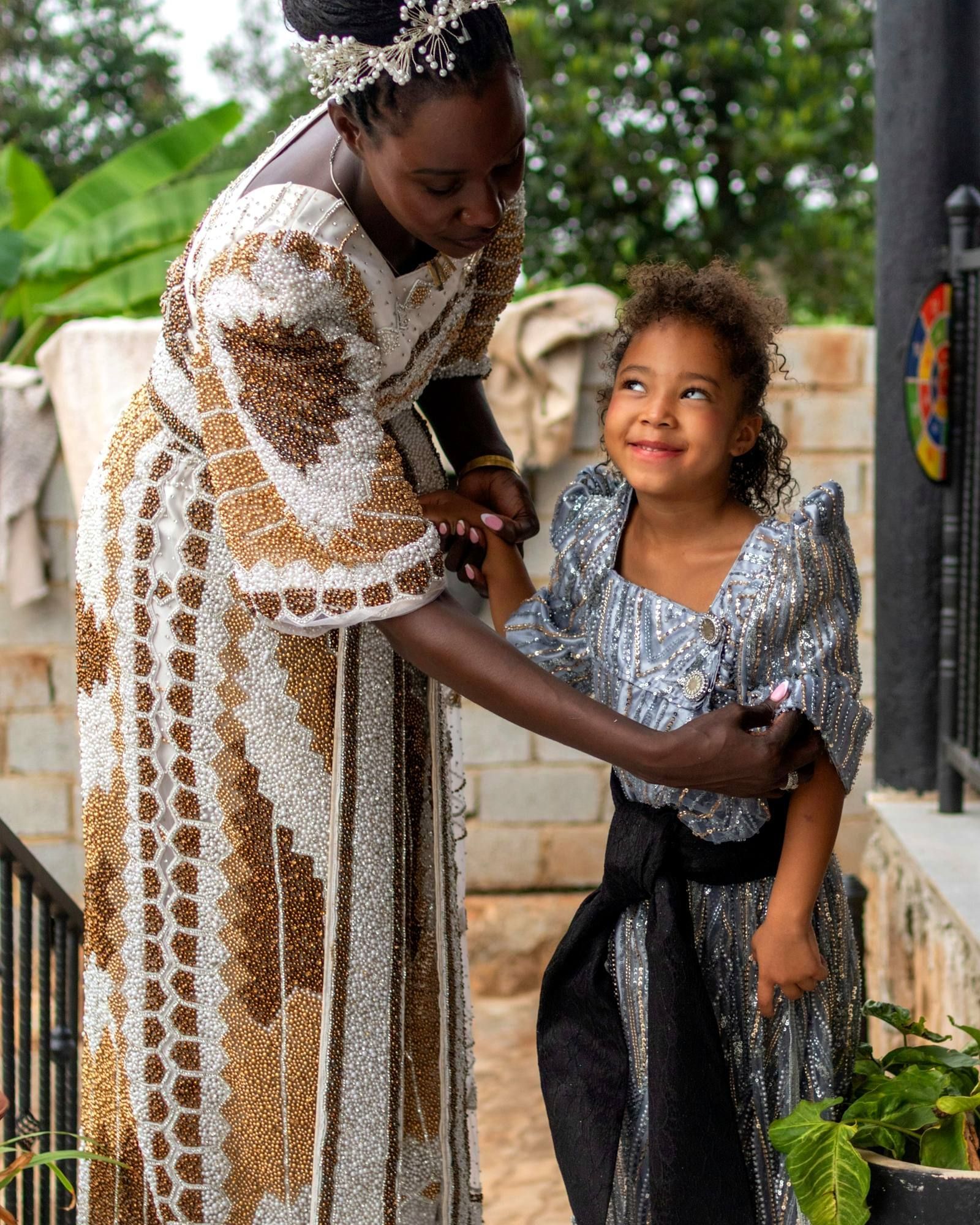 A mother straightening her daughter's collar before church