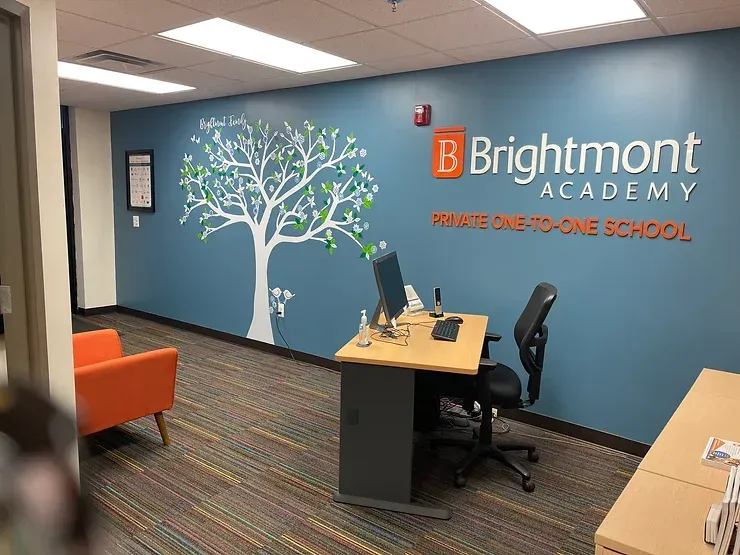 Desk with Brightmont Academy Logo on wall