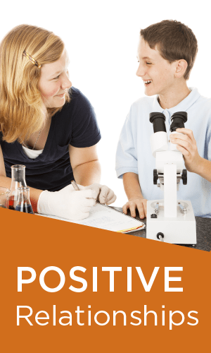 A woman and a boy are looking through a microscope.