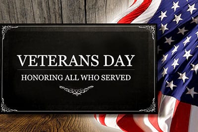 A sign that says veterans day honoring all who served