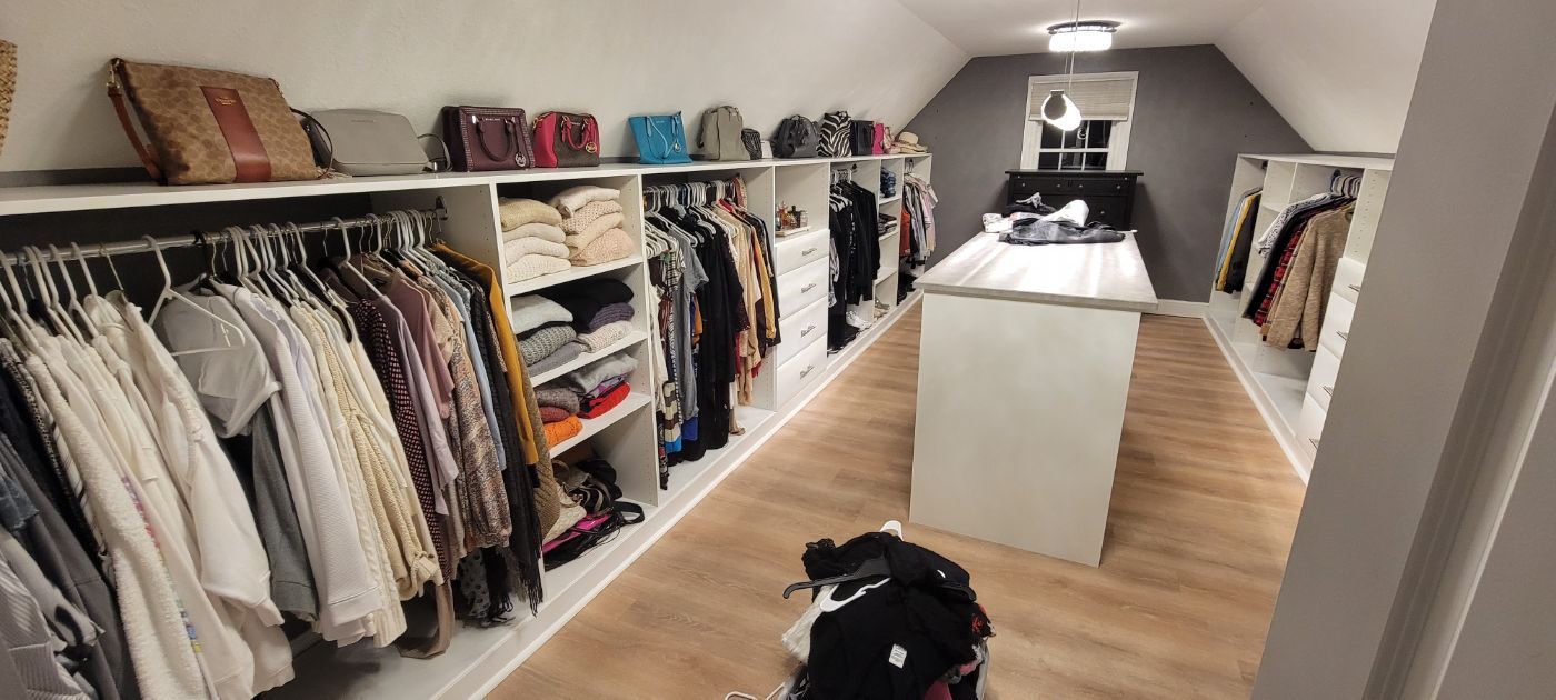 a custom closet filled with clothes .