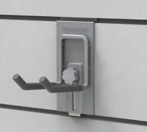 Gray metal hook mounted on a white slatwall. It has two curved arms for hanging items.