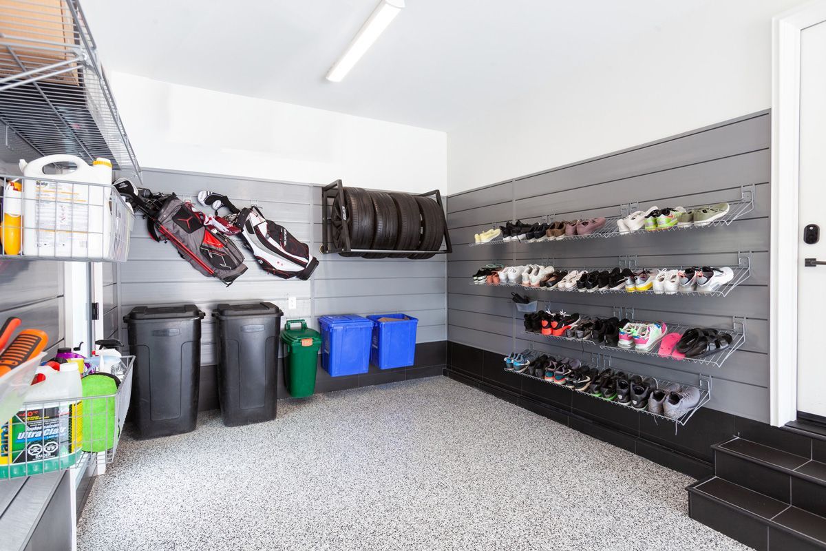 A CrownWall Slatwall Organization System with Shoe, Golf, and Tire Storage Organizers