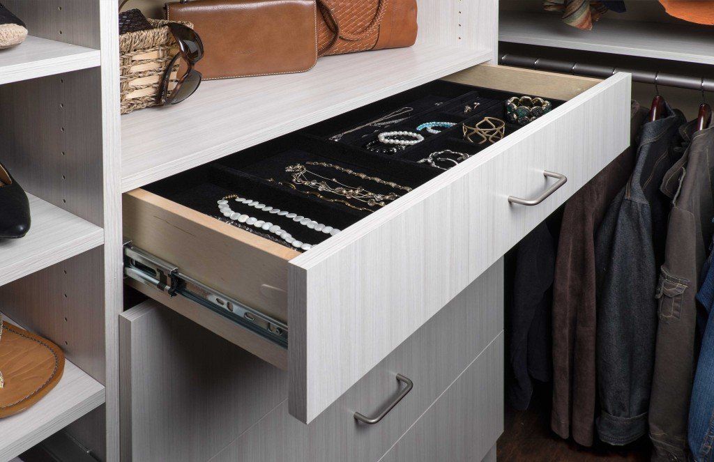 White closet drawer with jewelry storage, pulled open.