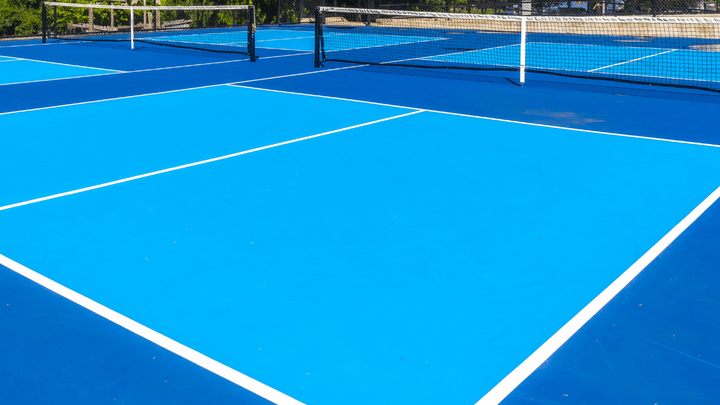 Bright blue pickleball court with crisp white boundary lines and a smooth surface after a court installation service in San Tan Valley, AZ