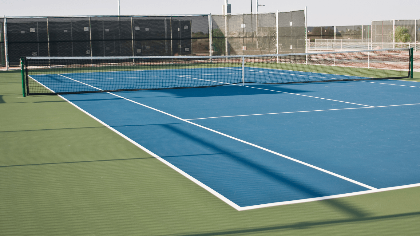 Fresh blue tennis court with clean white lines and green borders after a court installation service in San Tan Valley, AZ