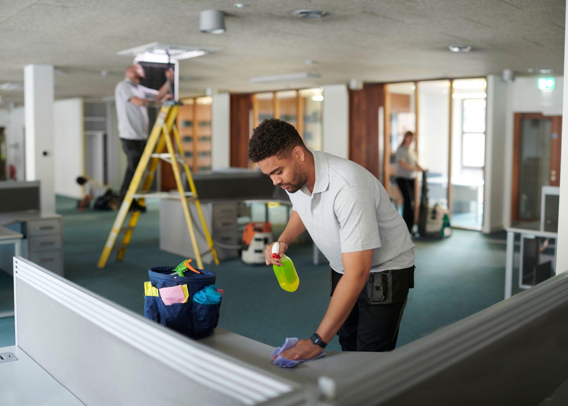 A team is doing a deep cleaning of an office.