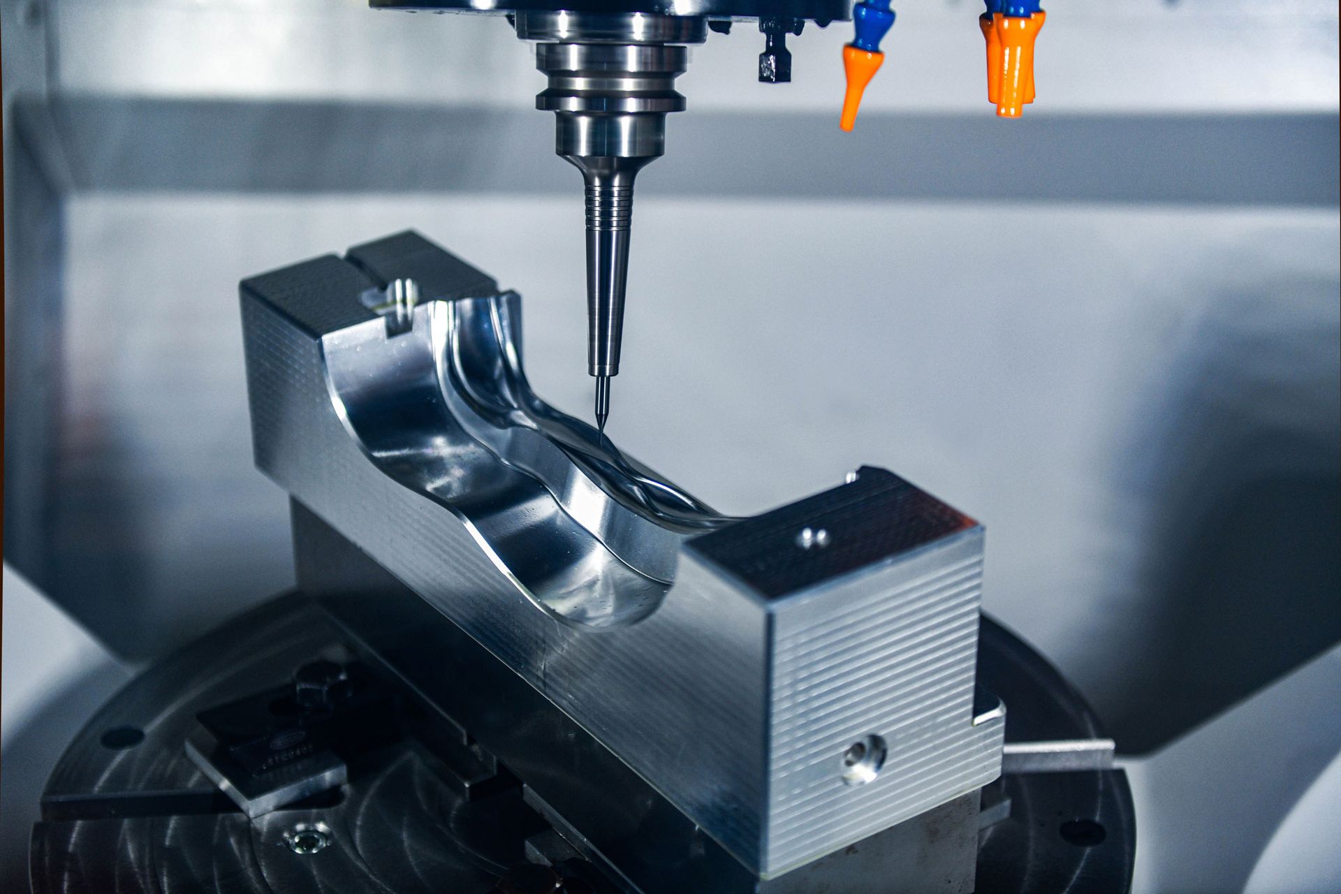 A machine is cutting a piece of metal on a table.