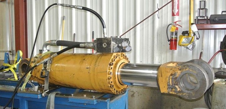 Hydraulic Cylinder Is Sitting On Top Of A Blue Table — Lincoln, NE — Central States Hydraulic Services