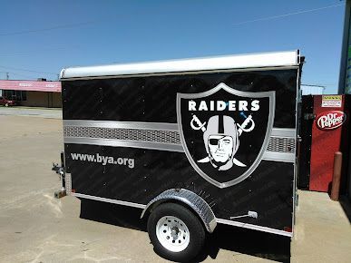 A black trailer with the raiders logo on it