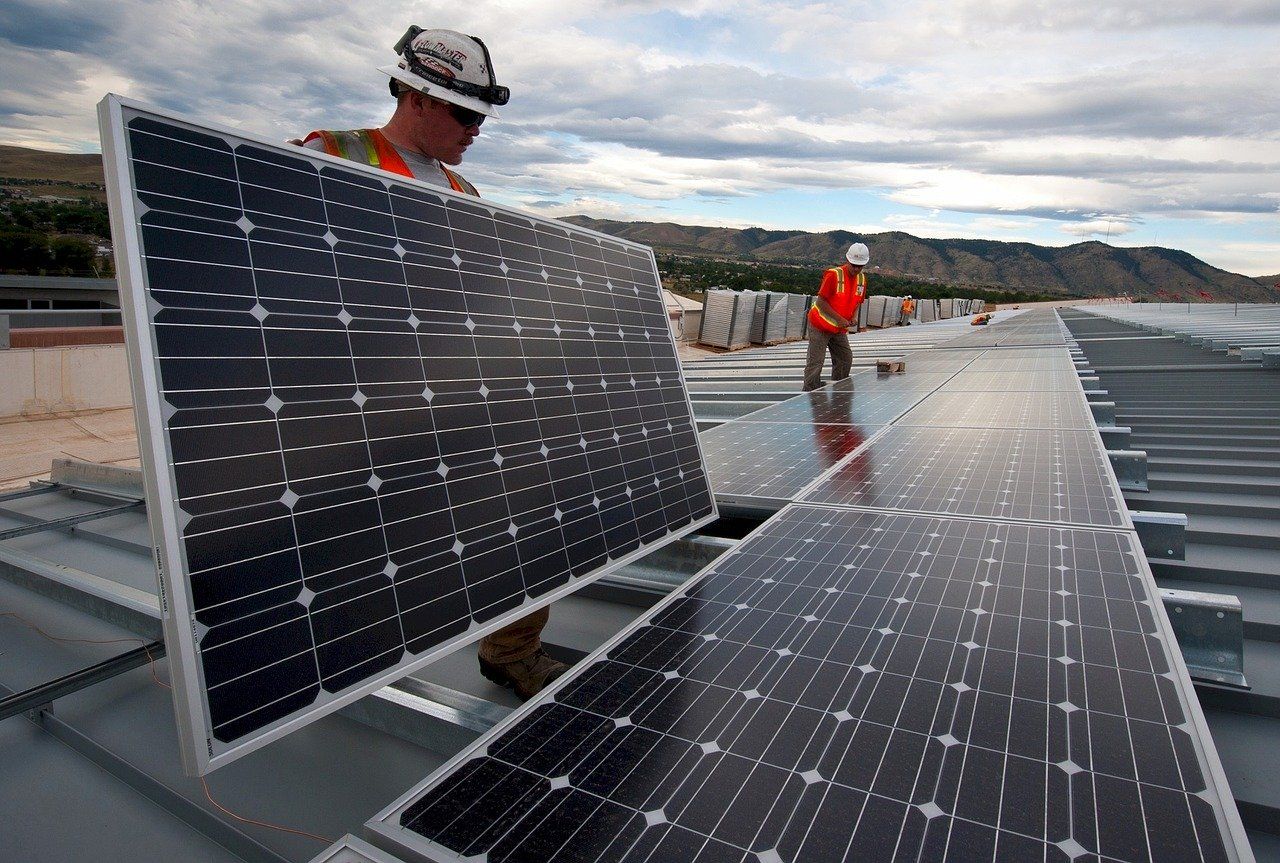 Worker Installing a Solar Panel on Roof — Ryde Energy in Browns Plains, QLD