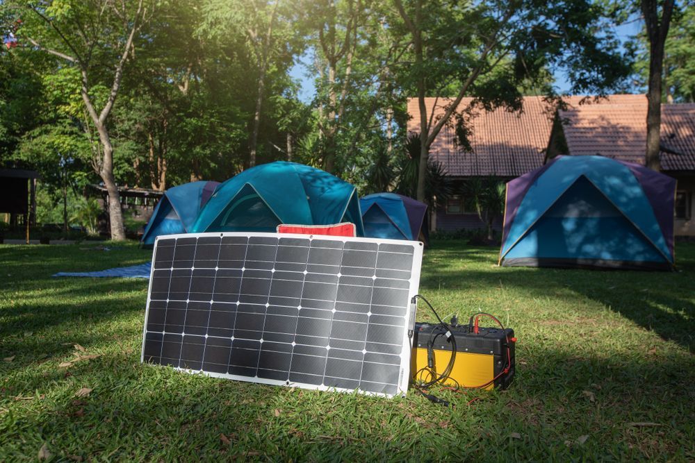 Solar Panel and Battery Setup Beside Blue Tents — Ryde Energy in Browns Plains, QLD