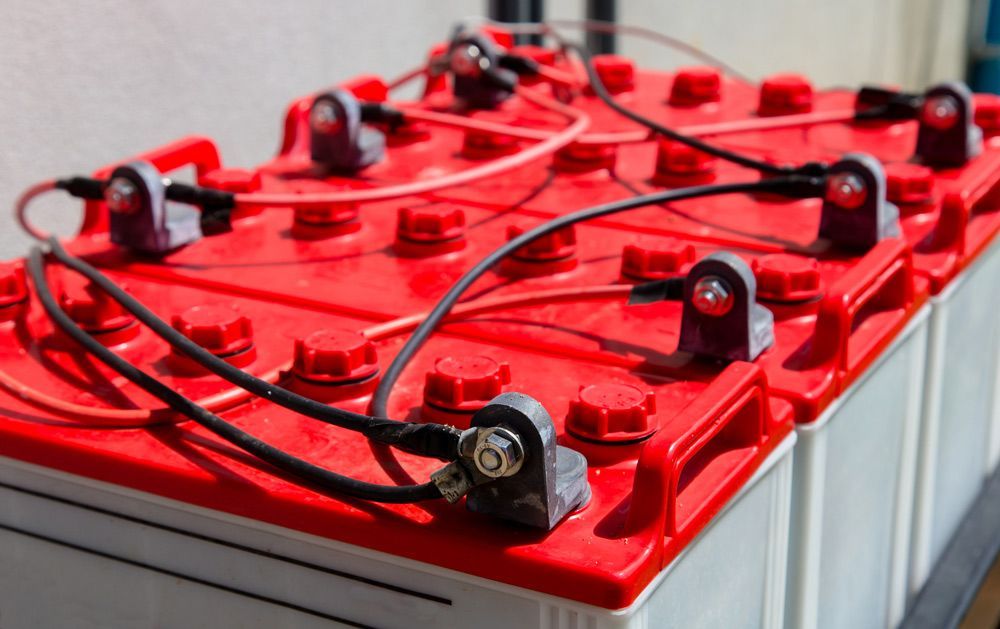 A Bunch of Solar Batteries Are Sitting on Top of Each Other on A Table — Ryde Energy in Toowoomba, QLD