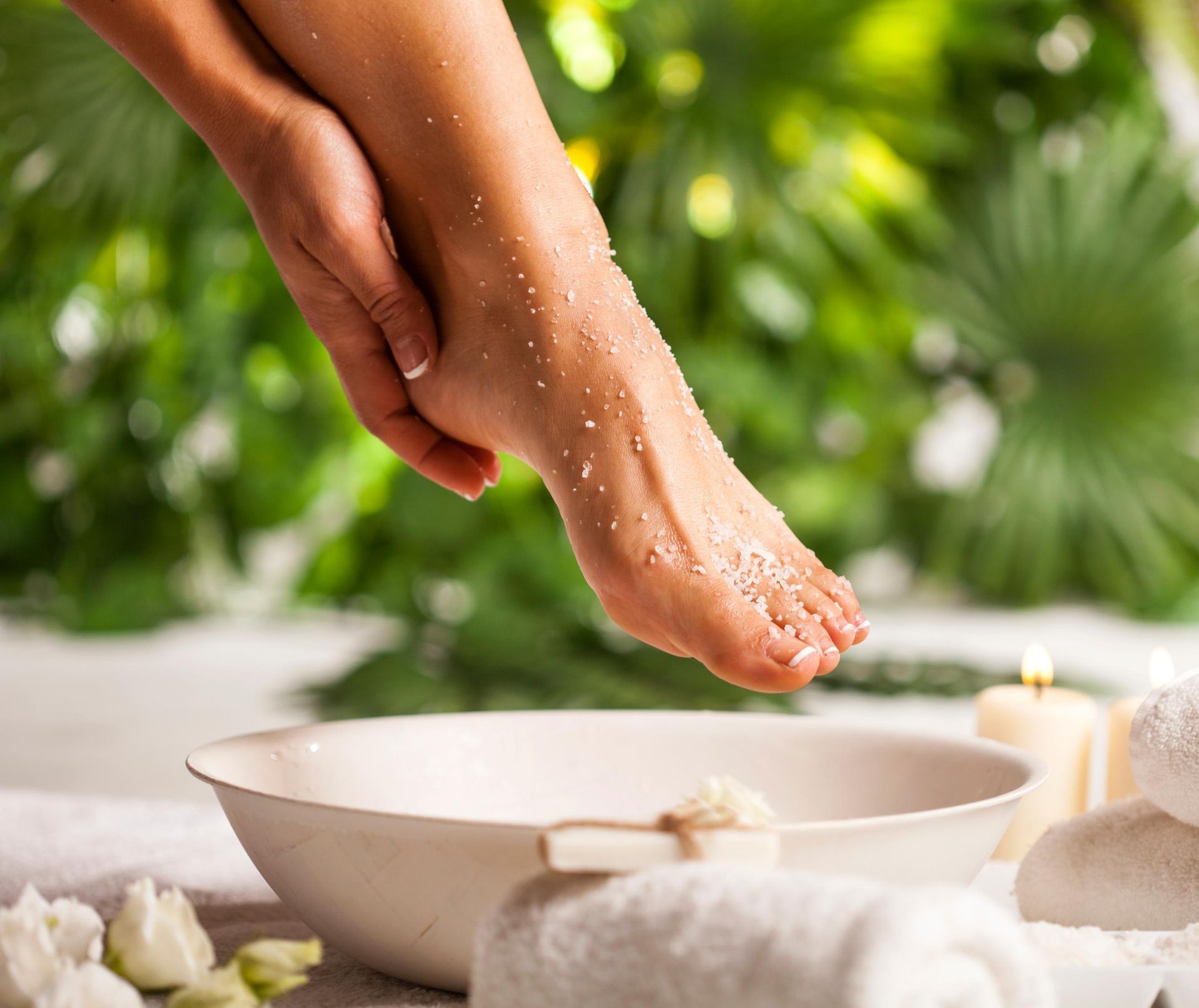 A woman is scrubbing her feet in a bowl.