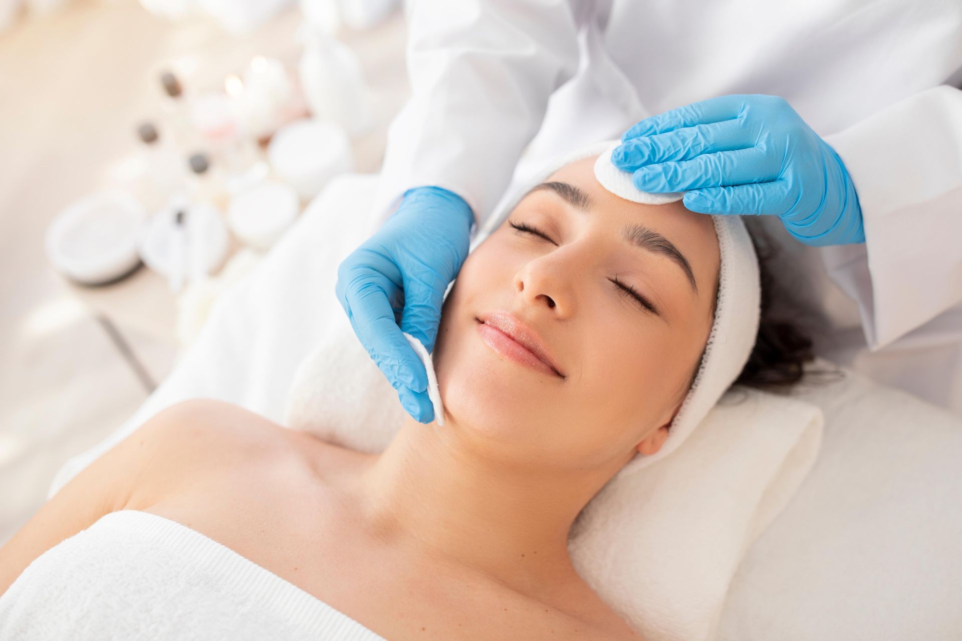 A woman is getting a facial treatment at a spa.