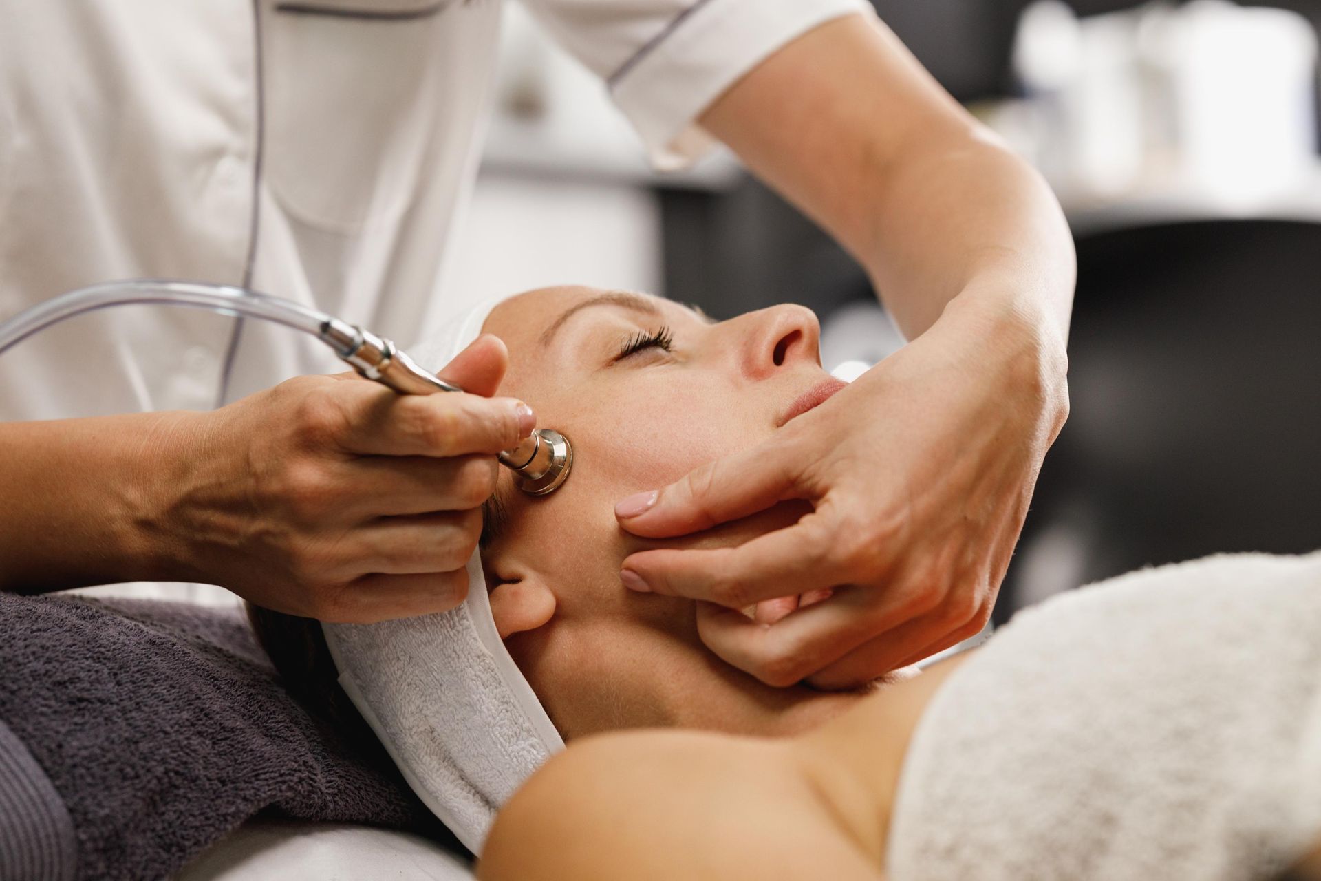 Shot of a beautiful woman on a microdermabrasion facial treatment.