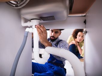 Plumber Fixing a Sink — Plumber in Moranbah, QLD