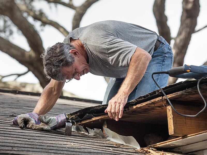 Man Fixing a Roof — Roofing in Moranbah, QLD Man Fixing a Roof — Roofing in Moranbah, QLD
