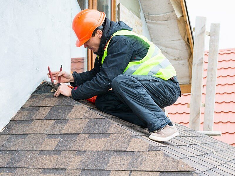 Worker Repairing Roof — Roofing in Moranbah, QLD Worker Repairing Roof — Roofing in Moranbah, QLD