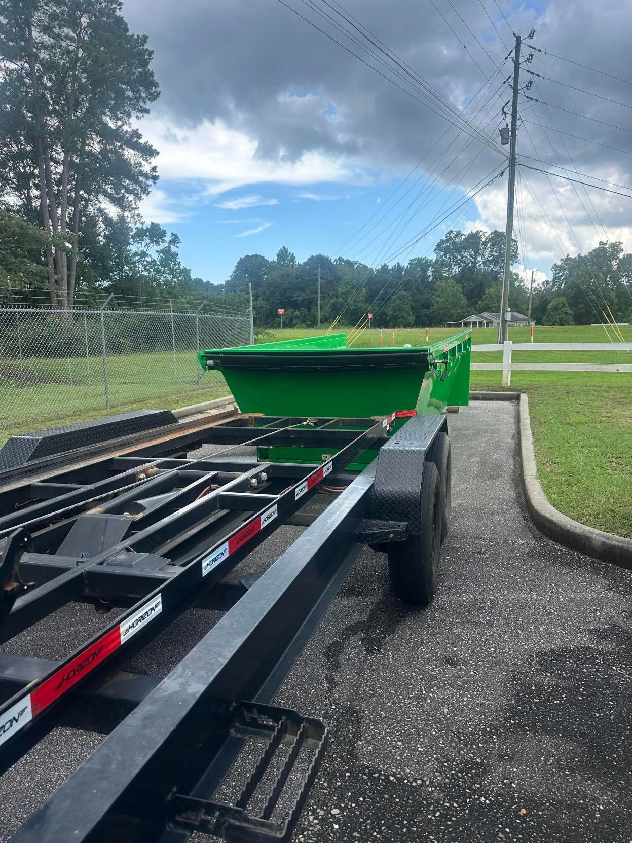 Dumpster rental being dropped off in Andalusia, AL