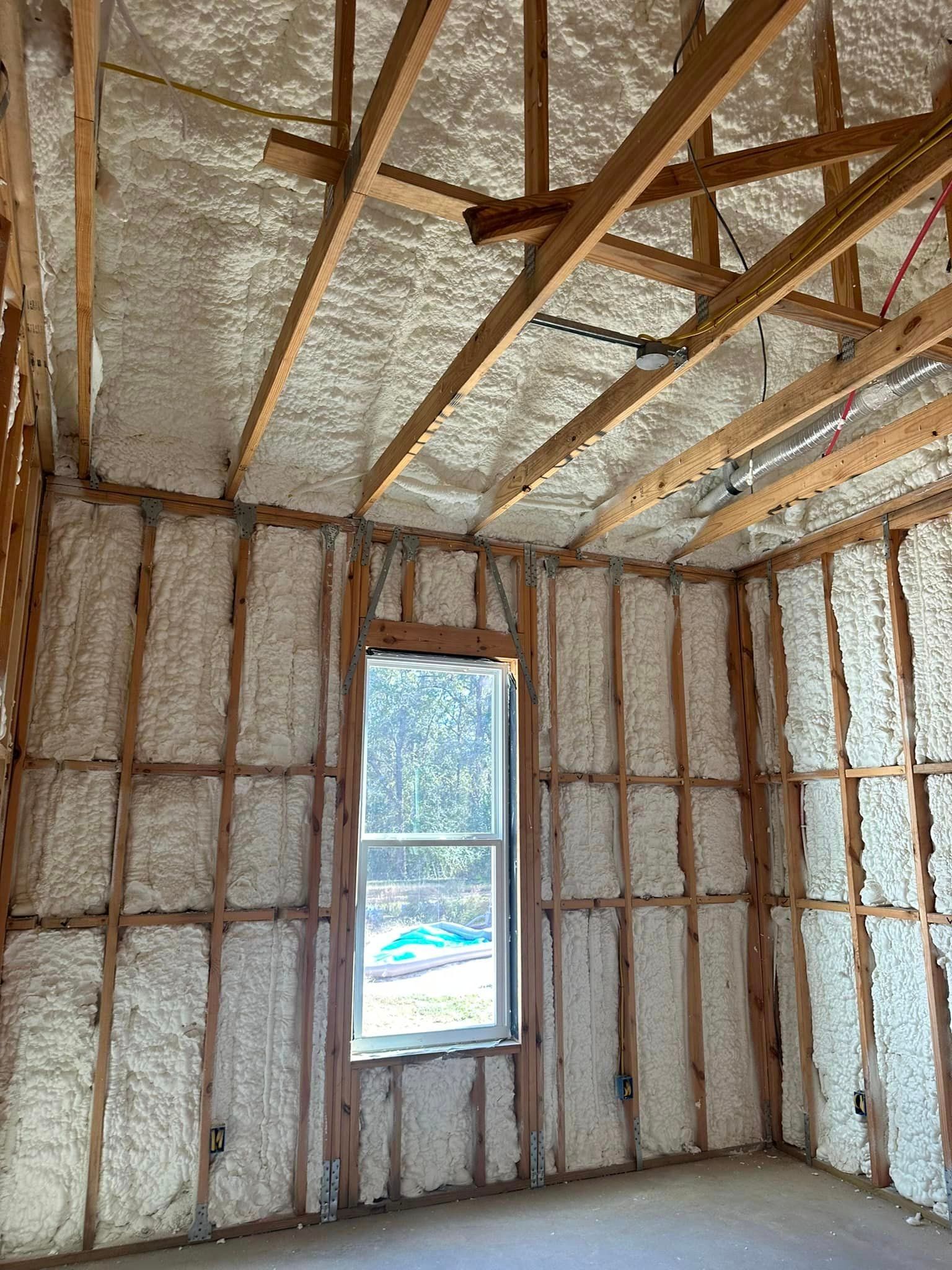 a room with foam on the walls and ceiling and a window .