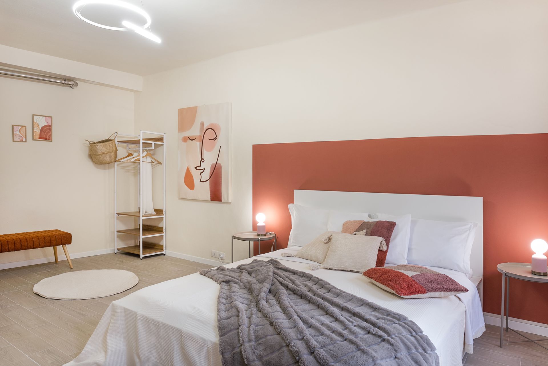 Double bed and terracotta wall.