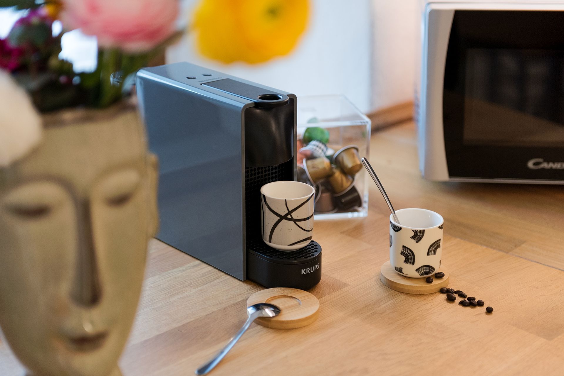 Close-up of the coffee corner featuring a capsule machine Nespresso, coffee cups.