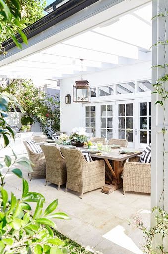 Hanging light fixture over outdoor dining area