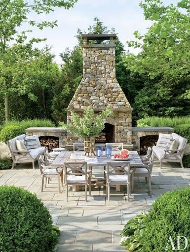 Stone patio with outdoor dining set and fireplace