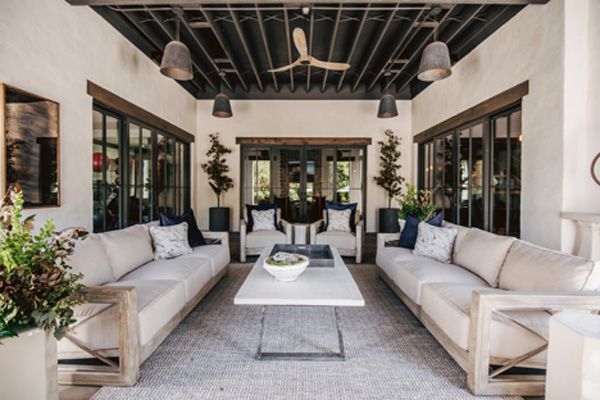 Small outdoor living area with hanging lights, ceiling fan, and seating area