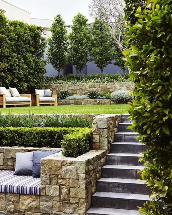 Small Grassy outdoor patio with stone steps and outdoor seating