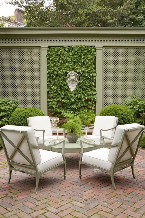 small garden patio with outdoor seating and table