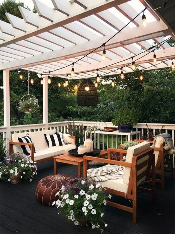 Small outdoor porch with patio furniture and hanging lights