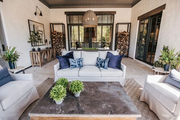 Small outdoor living area with couch seating and hanging light